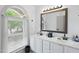 Bathroom featuring a double vanity, large windows, and neutral countertops at 7116 Incline Dr, Wake Forest, NC 27587