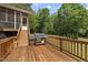 Wooden deck with a built-in grill and stairs leading to the backyard at 7116 Incline Dr, Wake Forest, NC 27587