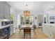Bright dining area with modern chandelier and a beverage refrigerator nearby at 7116 Incline Dr, Wake Forest, NC 27587