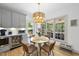 Bright dining area with modern chandelier, views of the backyard and a beverage refrigerator nearby at 7116 Incline Dr, Wake Forest, NC 27587