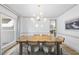 Bright dining room features a wooden table, modern chandelier, and serene ambiance at 7116 Incline Dr, Wake Forest, NC 27587