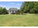 Back exterior showcasing a well-maintained home, screened porch, and spacious yard at 7116 Incline Dr, Wake Forest, NC 27587