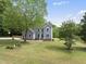 Stunning home exterior with lush green lawn, mature trees, and inviting curb appeal at 7116 Incline Dr, Wake Forest, NC 27587