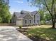 Beautiful home with attached garage, gray siding, and well-manicured landscaping at 7116 Incline Dr, Wake Forest, NC 27587