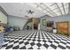 Spacious garage featuring a checkerboard floor, a loft area, and ample workspace for hobbies or projects at 7116 Incline Dr, Wake Forest, NC 27587