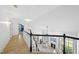 Hallway with hardwood floors, white railings, and an open view of the living room below at 7116 Incline Dr, Wake Forest, NC 27587