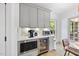 Kitchen featuring stainless steel appliances, stone countertops and beverage refrigerator at 7116 Incline Dr, Wake Forest, NC 27587