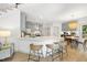 Bright open kitchen featuring a large island with seating, modern cabinets, stainless steel appliances and wood floors at 7116 Incline Dr, Wake Forest, NC 27587