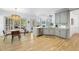 Bright kitchen and dining area with stainless steel appliances, stone countertops and backsplash, and wood floors at 7116 Incline Dr, Wake Forest, NC 27587