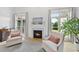 Inviting living room with a cozy fireplace, neutral tones, and natural light streaming through windows at 7116 Incline Dr, Wake Forest, NC 27587