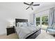 Large main bedroom with vaulted ceiling, ceiling fan, large window and a bedside table at 7116 Incline Dr, Wake Forest, NC 27587