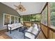 Inviting screened porch featuring wood floors and comfortable outdoor furniture at 7116 Incline Dr, Wake Forest, NC 27587