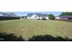 Expansive backyard features a green lawn, white home and wooden fence at 74 Pedernales Dr, Smithfield, NC 27577
