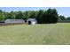 Expansive backyard featuring a storage shed, lawn, privacy fence, and mature trees at 74 Pedernales Dr, Smithfield, NC 27577