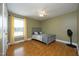 Bedroom with hardwood floors, ceiling fan, window, a bed frame and a black fan at 74 Pedernales Dr, Smithfield, NC 27577