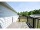 View from wooden deck of a fenced in yard with a detached garage at 74 Pedernales Dr, Smithfield, NC 27577