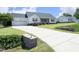 Picture shows the house's long, paved driveway leading to a two-car garage and landscaped front yard at 74 Pedernales Dr, Smithfield, NC 27577