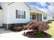 Detail of house showing landscaped yard and mature landscaping surrounding the front of the home at 74 Pedernales Dr, Smithfield, NC 27577