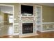 Close up of the stone fireplace with display shelving in the living room of the home at 74 Pedernales Dr, Smithfield, NC 27577