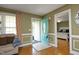 Light-filled foyer with hardwood floors, a colorful front door, and a view into the main bedroom at 74 Pedernales Dr, Smithfield, NC 27577