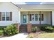Inviting covered front porch with brick columns and an updated front door at 74 Pedernales Dr, Smithfield, NC 27577