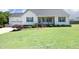 Charming home featuring a manicured lawn and a welcoming front porch with brick accents at 74 Pedernales Dr, Smithfield, NC 27577