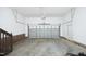 Spacious garage with white walls, high ceilings, and a door to the exterior at 74 Pedernales Dr, Smithfield, NC 27577