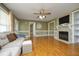 Spacious living room with a fireplace, built-in shelving, and large windows at 74 Pedernales Dr, Smithfield, NC 27577