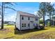 Back exterior view featuring a deck, large backyard and manicured lawn at 7729 Calcutta Dr, Willow Springs, NC 27592