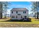 Back exterior view featuring a deck, large backyard and two-story construction at 7729 Calcutta Dr, Willow Springs, NC 27592