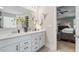 The primary bathroom boasts double sinks with white cabinets and black hardware, and a door to the bedroom at 7729 Calcutta Dr, Willow Springs, NC 27592
