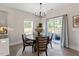 Bright dining area with a round table, modern chandelier, and sliding glass doors at 7729 Calcutta Dr, Willow Springs, NC 27592