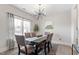 Elegant dining room featuring a modern chandelier and a large window, creating a bright atmosphere at 7729 Calcutta Dr, Willow Springs, NC 27592