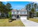Charming two-story home with a covered front porch and well-manicured lawn at 7729 Calcutta Dr, Willow Springs, NC 27592
