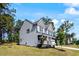 Side view of a beautiful home with a well-maintained yard and inviting front porch at 7729 Calcutta Dr, Willow Springs, NC 27592