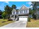 Beautiful two-story home featuring a welcoming covered porch and attached garage at 7729 Calcutta Dr, Willow Springs, NC 27592