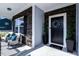 Inviting front porch with stylish seating area and decorative potted plants near the entrance at 7729 Calcutta Dr, Willow Springs, NC 27592
