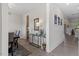 Bright hallway with modern decor, leading to various rooms in the house, featuring elegant flooring at 7729 Calcutta Dr, Willow Springs, NC 27592