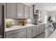 Gourmet kitchen with gray cabinets, modern backsplash, and stainless steel appliances at 7729 Calcutta Dr, Willow Springs, NC 27592