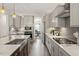 Beautiful kitchen featuring stainless steel appliances, stylish lighting, and gray cabinets at 7729 Calcutta Dr, Willow Springs, NC 27592