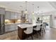 Bright kitchen with island seating, stainless appliances, and view to the dining area at 7729 Calcutta Dr, Willow Springs, NC 27592