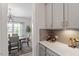 Cozy kitchenette featuring gray cabinets, modern lighting, and wine storage at 7729 Calcutta Dr, Willow Springs, NC 27592