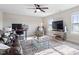 Spacious living room featuring dual workspaces, a leather couch and natural light at 7729 Calcutta Dr, Willow Springs, NC 27592