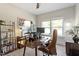 A well-lit home office features a sleek desk setup and shelving with decorative items, creating an inviting workspace at 7729 Calcutta Dr, Willow Springs, NC 27592