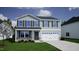 Charming two-story home featuring gray siding, black shutters, and an attached two-car garage at 85 Cordoba Dr, Franklinton, NC 27525