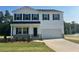 Charming two-story home with a traditional design, white siding, dark shutters, and a well-manicured lawn at 85 Cordoba Dr, Franklinton, NC 27525
