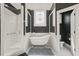 Bathroom featuring a walk in shower and freestanding soaking tub at 8524 Society Pl, Raleigh, NC 27615