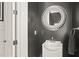 Powder bathroom featuring black walls and a decorative mirror at 8524 Society Pl, Raleigh, NC 27615