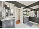Dual sink vanity with a marble countertop and decorative mirrors in the bathroom at 8524 Society Pl, Raleigh, NC 27615