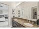 Bathroom with double sinks, granite countertops and large framed mirror at 8524 Society Pl, Raleigh, NC 27615